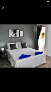 a bedroom with a large white bed with blue sheets at landmark karon in Karon Beach
