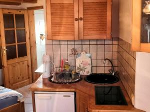 
a kitchen with a sink, stove, and dishwasher at Bungalow Poggendorf in Eldena
