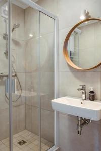 a bathroom with a shower and a sink and a mirror at Seaside bent in Juodkrantė
