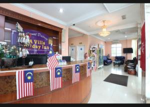 a lobby of a villa dairy inn with american flags at SA VILLA HOLIDAY INN in Kota Bharu