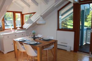 a dining room with a wooden table and chairs at Ferienwohnung Bernau in Bernau am Chiemsee