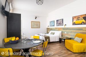 a hotel room with a bed and a table and chairs at Z8 Apartments in Bologna