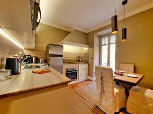 a kitchen with a counter and a table in a room at Hotel Balestri - WTB Hotels in Florence