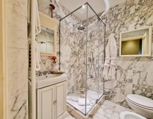 a bathroom with a shower and a toilet and a sink at Hotel Balestri - WTB Hotels in Florence +37 photos