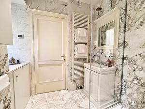 a white bathroom with a sink and a mirror at Hotel Balestri - WTB Hotels in Florence