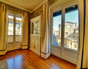 an empty room with a large window and a door at Hotel Balestri - WTB Hotels in Florence