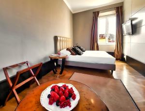 a living room with a table with a cake on it at Hotel Balestri - WTB Hotels in Florence