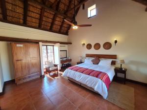 a bedroom with a large bed in a room at Zebula No 2 Waterbergs Over the Savannah 4 Bedroom in Mabula