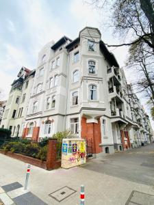 a large white building with a clock on it at Hannover List 2 bedroom home away from home in Hannover