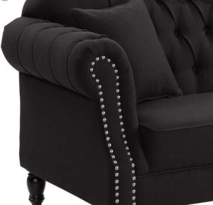 a black couch with pearl buttons on it at Chez Vous French Farmhouse Villa 3! in Pokolbin