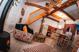 a living room with a couch and a stove at Chalets Dedinky in Dedinky