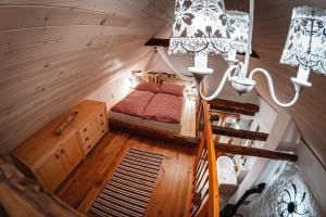 an attic room with a bed and a staircase at Chalets Dedinky in Dedinky