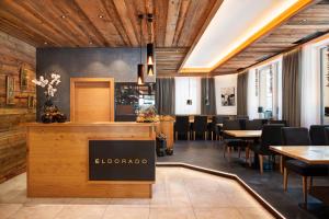 a restaurant with wooden ceilings and tables and chairs at Hotel Eldorado in Ischgl