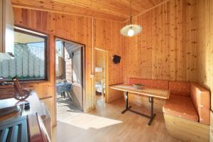 a room with a bench and a table and a window at Casa Genziana in Barzio