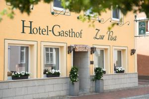 
a building with a sign on the front of it at Hotel Gasthof Zur Post in Bad Abbach
