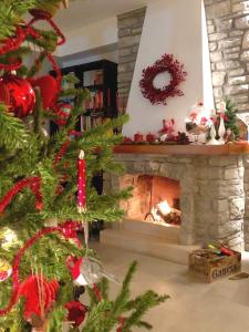 a christmas tree in a living room with a fireplace at Villa Maria Luxury Suites in Sperlonga