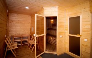 a room with a sauna with two chairs and a table at Комплекс Fit Life in Brody