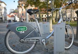a bicycle is parked on a brick street at Family Guesthouse GreenSLO in Ljubljana
