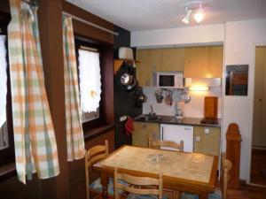 une cuisine avec une table en bois et une salle à manger dans l'établissement Studio Montgenèvre, 1 pièce, 4 personnes - FR-1-445-75, à Montgenèvre