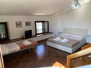 a bedroom with two beds and a flat screen tv at La casa del Duprè in Siena