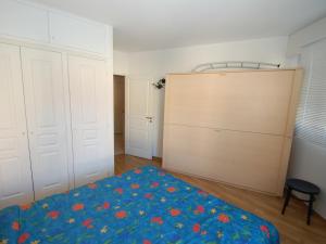 een slaapkamer met een bed met een blauwe deken bij Appartement Menton, 2 pièces, 4 personnes - FR-1-196-157 in Menton