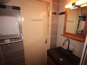 a bathroom with a sink and a mirror at Studio Les Saisies, 1 pièce, 2 personnes - FR-1-293-245 in Hauteluce