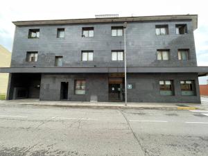 a large gray building with a lot of windows at Hotel Sant Celoni in Sant Celoni