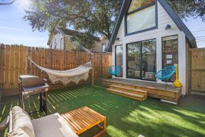 a backyard with a hammock and a fence at Unique A-frame Tiny House in Houston Central in Houston