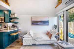 a living room with a couch and a table at Unique A-frame Tiny House in Houston Central in Houston