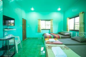 a blue room with two beds and a sink at บ้านเขาค้อริมธาร in Ban Non Na Yao