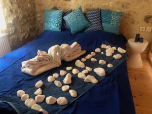 a bed with lots of towels and nuts on it at Guesthouse Arkadi Spa in Atsipopoulo
