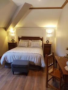 a bedroom with a bed and a wooden floor at Hotel Rural El Torrejon in Arenas de Cabrales