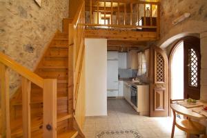 a kitchen with a wooden staircase in a house at Guesthouse Arkadi Spa in Atsipopoulo
