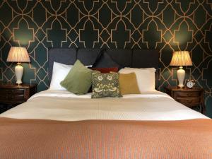 a bedroom with a large bed with pillows and two lamps at Moortown Lodge B&B in Ringwood