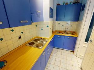 - une cuisine avec des placards bleus et un évier dans l'établissement Studio Menton, 1 pièce, 3 personnes - FR-1-196-276, à Menton