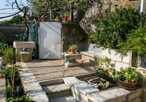 a garden with a door and some plants at Kusalo Guesthouse in Dubrovnik +24 photos