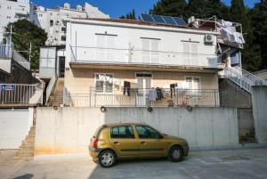 a small yellow car parked in front of a building at Kusalo Guesthouse in Dubrovnik