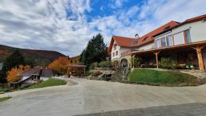 a large house with a driveway in front of it at Rudolf Vendégház in Velem