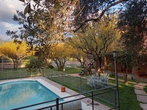 a swimming pool in a yard with trees at Cabañas La Belen in Merlo
