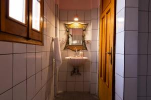 a bathroom with a sink and a mirror at ΜΕΤΕORΑ- KALAMBAKA- TRIKALA-Villa Toscana in Tríkala +28 photos