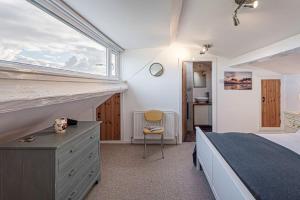 a bedroom with a large bed and a window at Llys Awel in Llangadwaladr