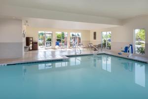 a large swimming pool with blue water in a building at Hyatt Place Reno/Tahoe Airport in Reno