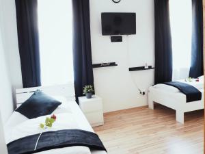 a bedroom with a bed and a tv on the wall at Monteurwohnung in Nuremberg