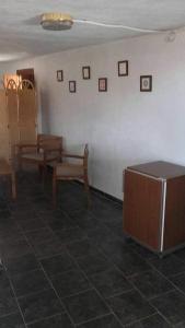 a room with tables and chairs and a white wall at Manxalo in Sant Mateu