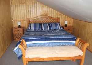 a bedroom with a wooden bed with two night stands at Turismo Vientos del Sur in Mallin Grande