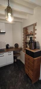 a kitchen with a counter and a stove in it at Gîte moderne à la campagne 6p max in La Couture