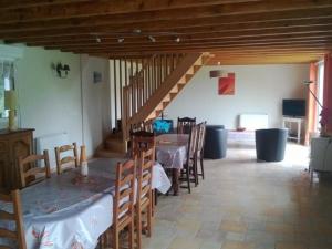 a dining room with a table and chairs and a staircase at Grande maison de campagne avec jardin, terrasse, accueil chevaux, proche plage de Wissant, animaux OK - FR-1-376-39 in Pihen-lès-Guînes +7 photos
