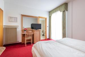 Voodi või voodid majutusasutuse Hotel Lucia toas
