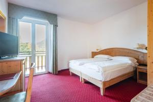 Voodi või voodid majutusasutuse Hotel Lucia toas