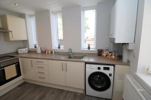 a kitchen with a washing machine and a sink at The Lodge IHMELB - APARTMENT 4 in Stockton-on-Tees